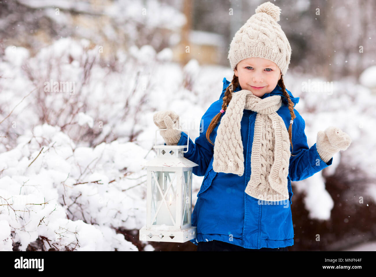 Entzückende kleine Mädchen halten Weihnachten Laterne im Freien an schönen Wintertag im Schnee Stockfoto