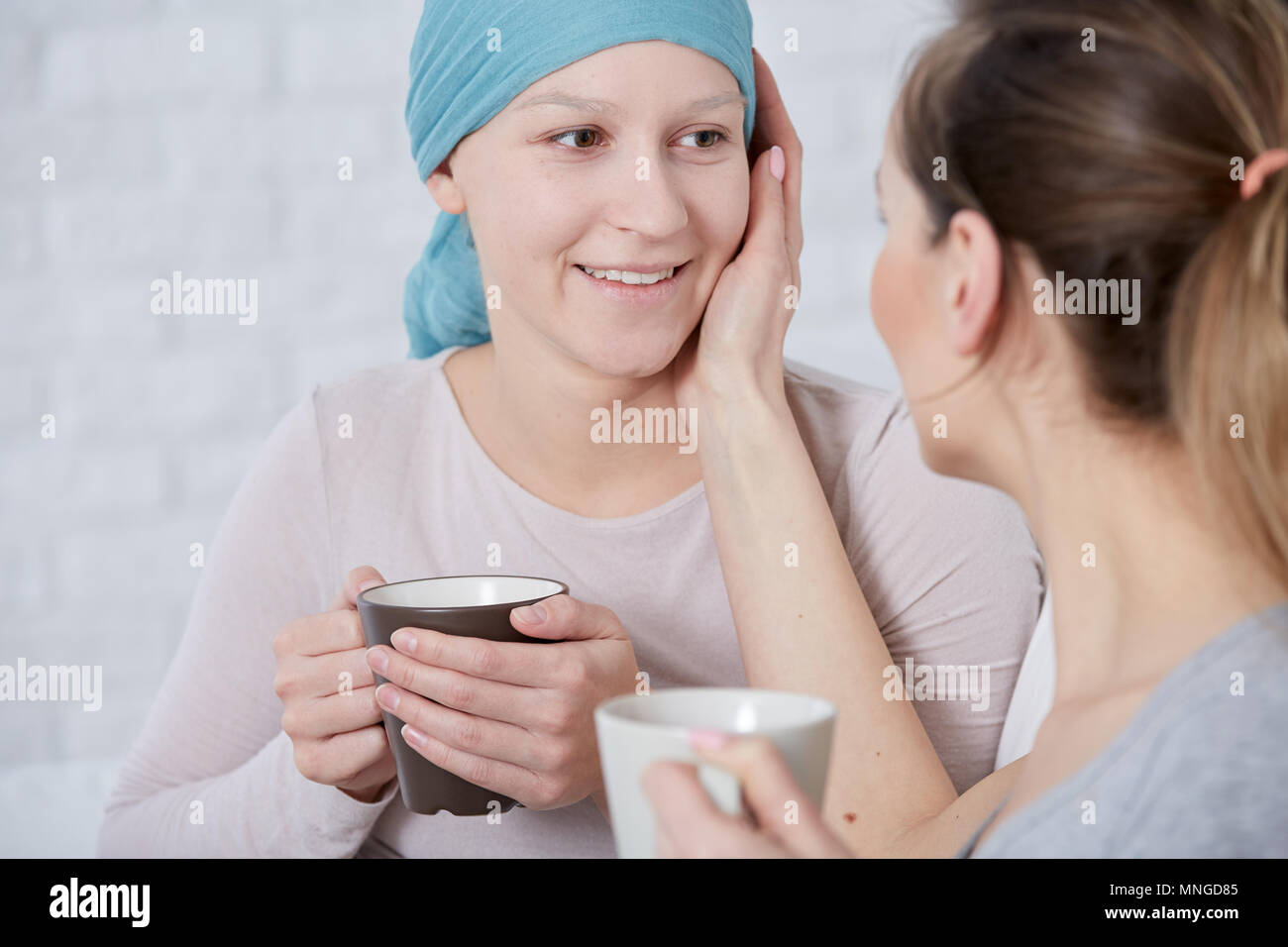 Frau, die ihren kranken Schwester, die unter Krebs leiden Stockfoto