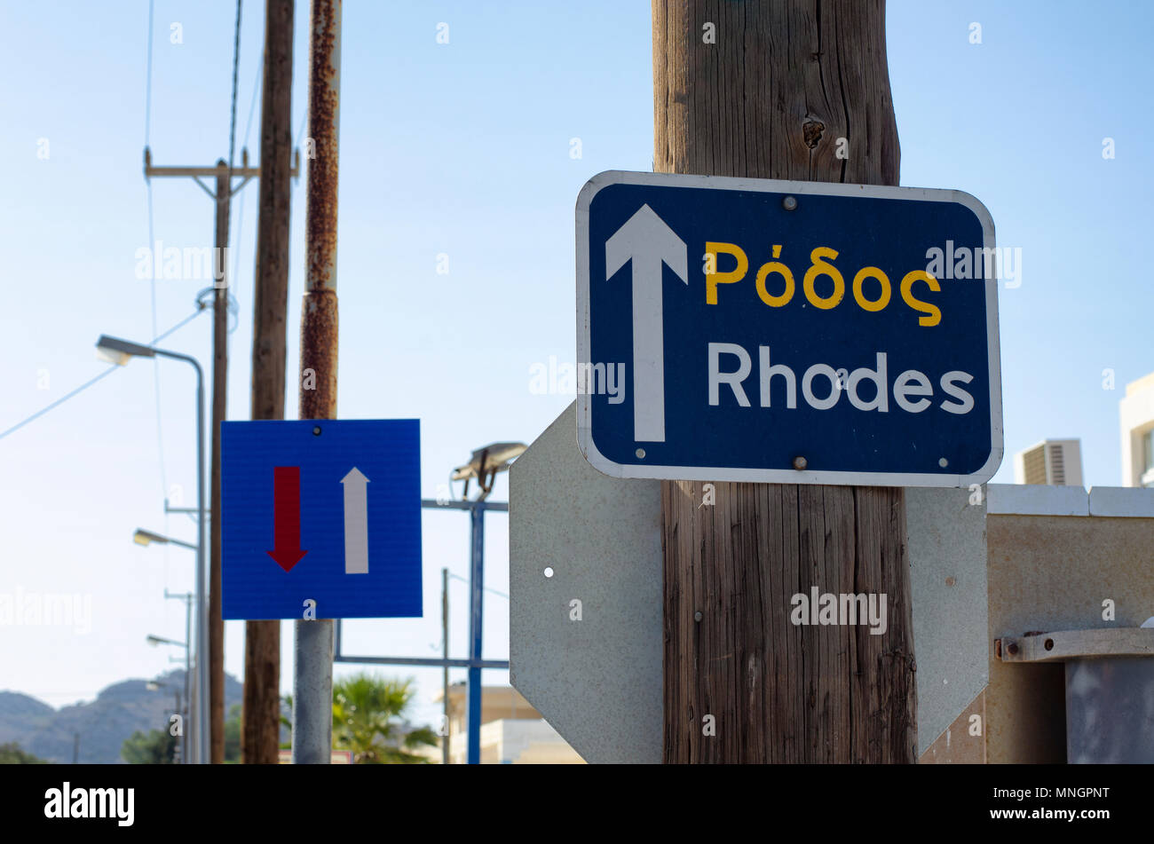 Straße Wegweiser mit der Aufschrift 'Rhodos' und Schild 'Bewegung' gegen den blauen Himmel Stockfoto