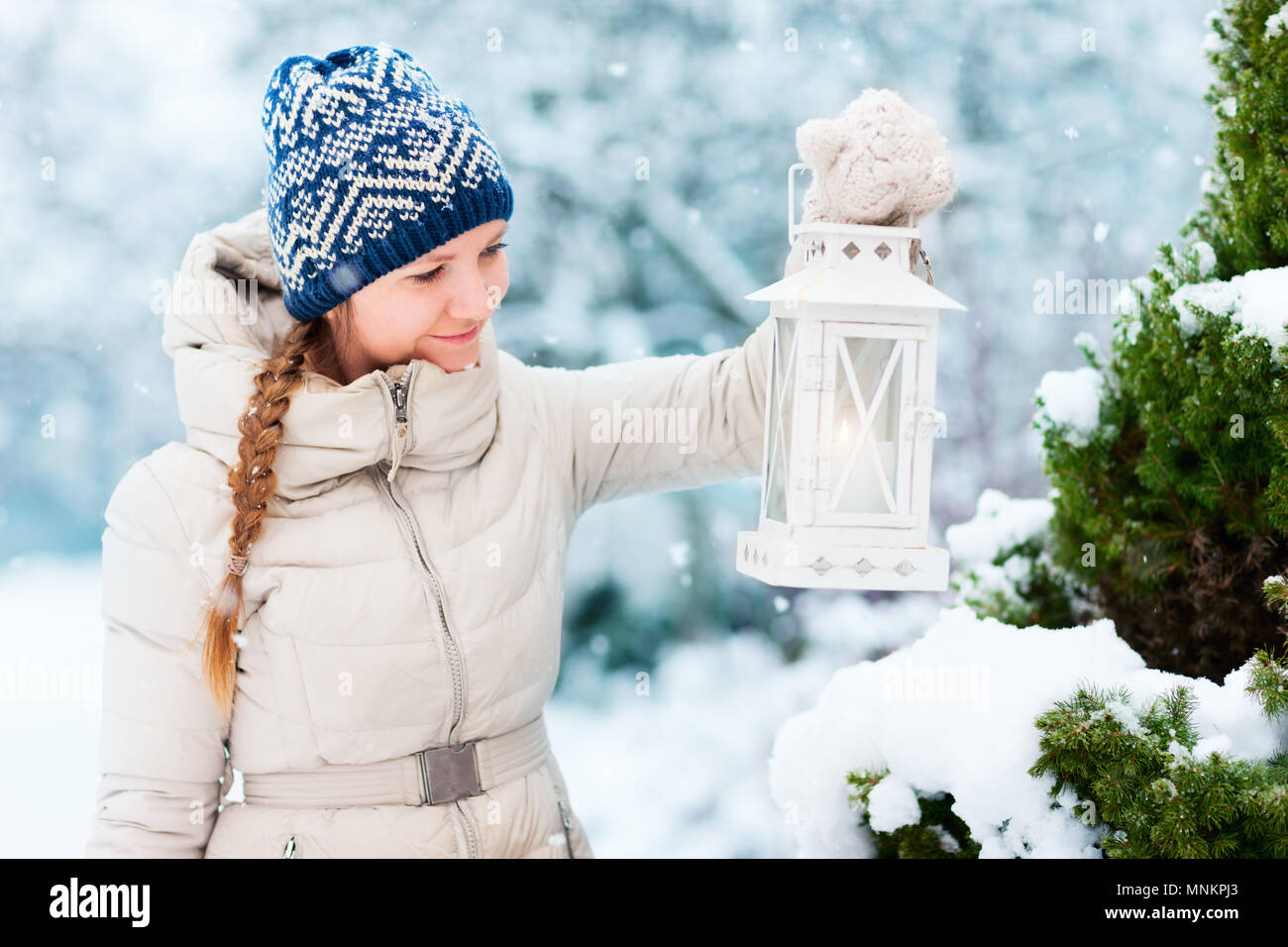 Junge Frau mit Weihnachten Laterne im Freien an schönen Wintertag im Schnee Stockfoto