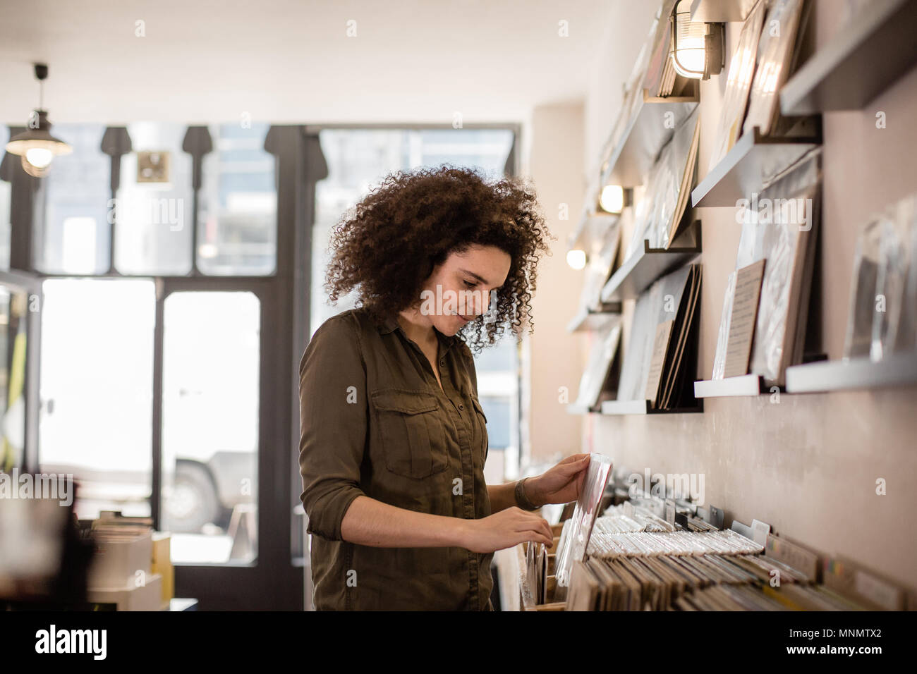 Junge Erwachsene Frauen auf der Suche nach Datensätzen in einem Store Stockfoto