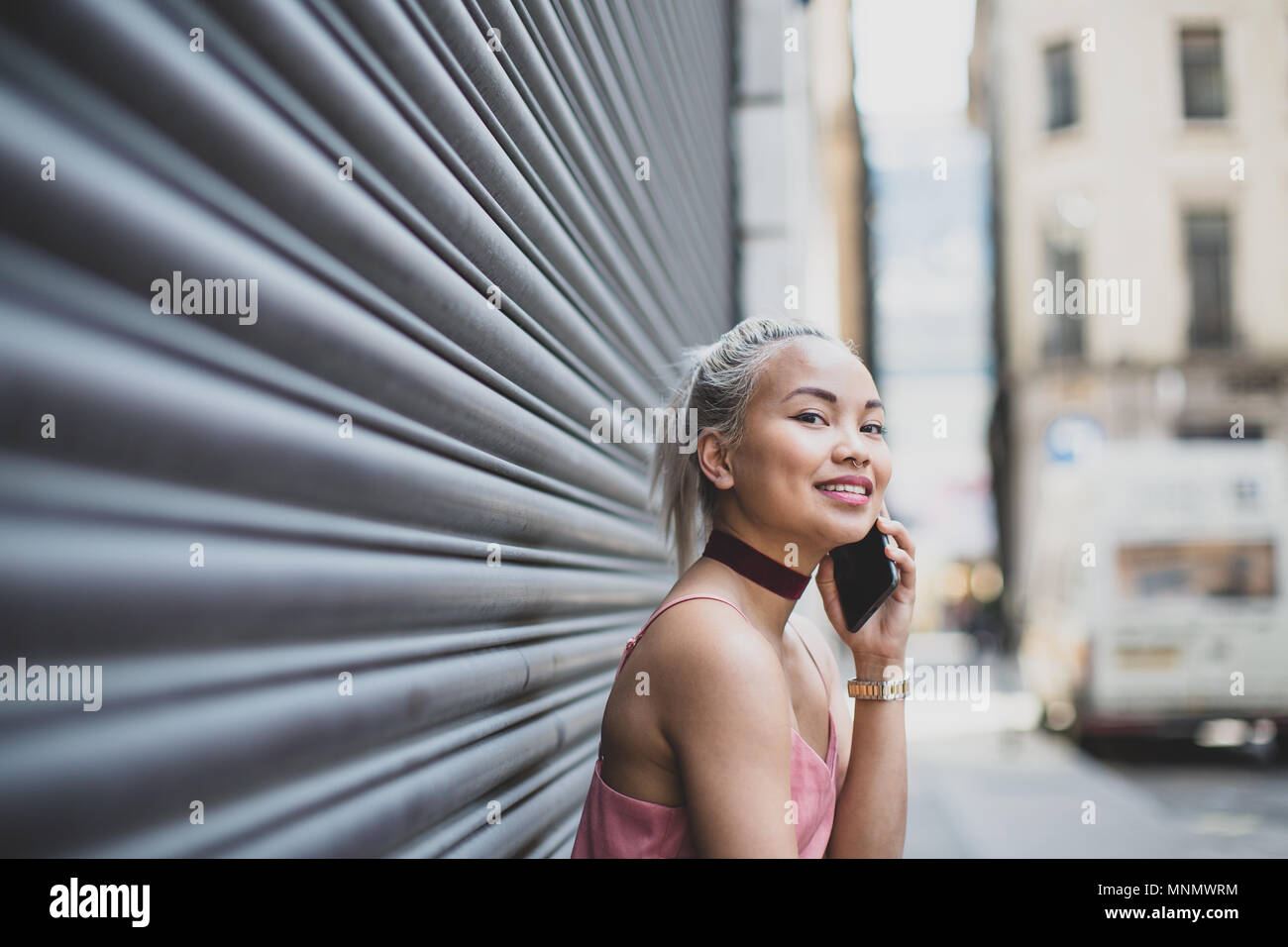 Junge erwachsene Frau auf dem Smartphone warten für einen Freund Stockfoto