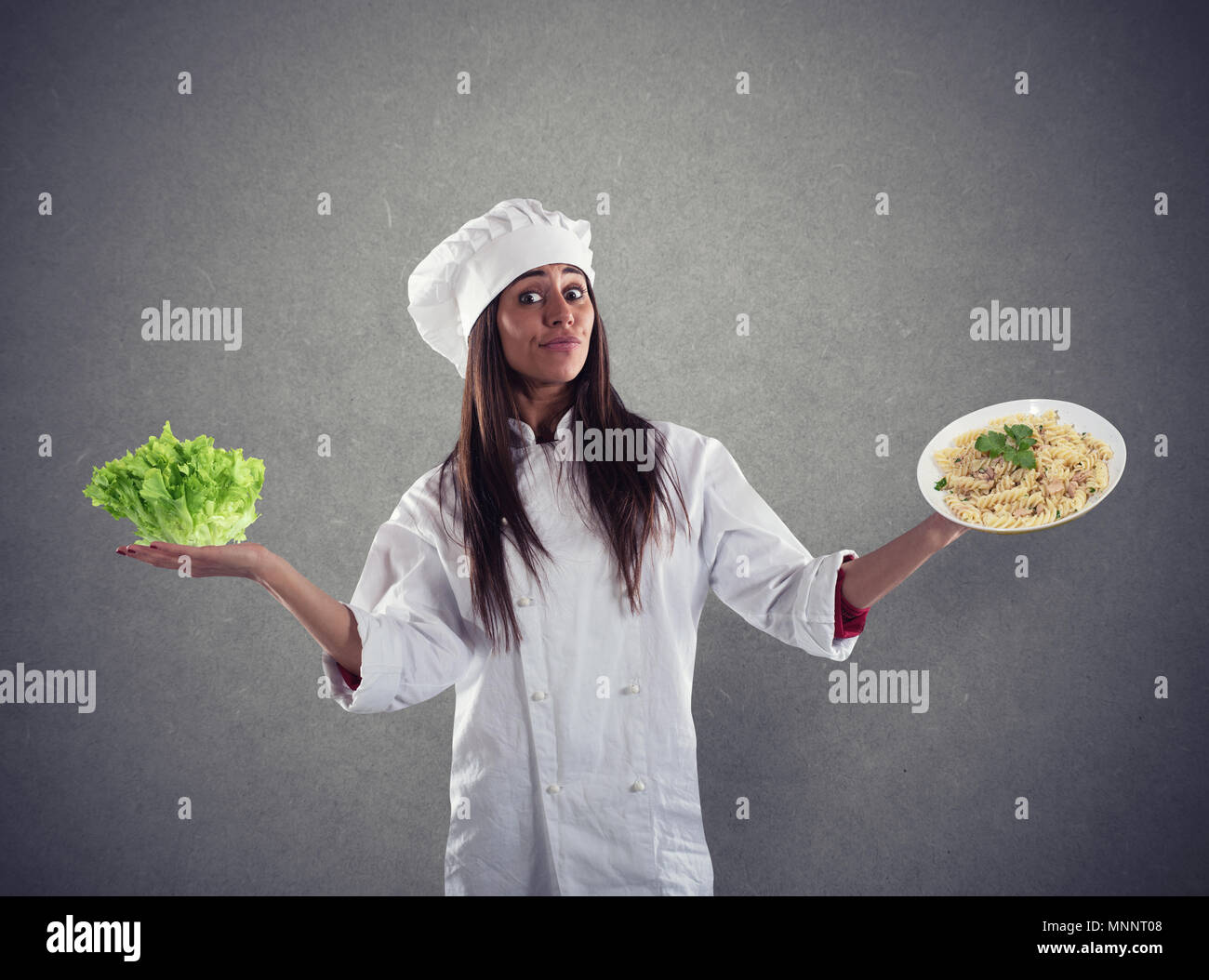 Koch zwischen frischem Salat oder Pasta unentschlossen Stockfoto