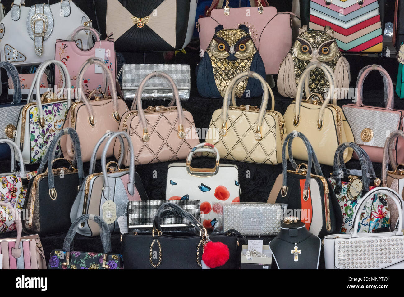 Eine Auswahl an designer handtaschen zum Verkauf auf einen Markt in einem  Stadtzentrum Einkaufszentrum oder Mall abgewürgt. Bling und funkelnden  glänzende Accessoires für Damen Stockfotografie - Alamy