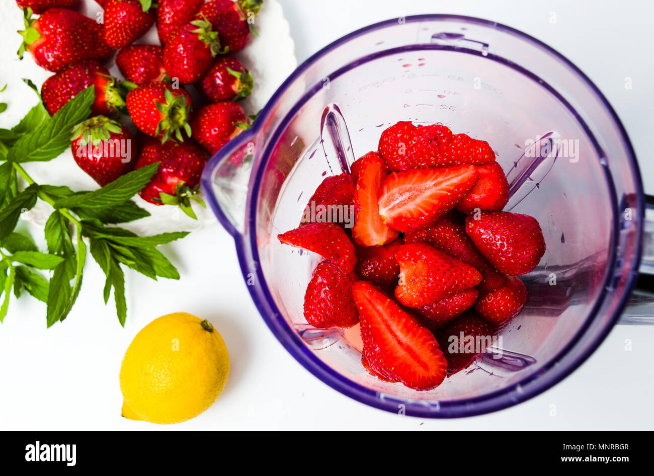 Strawberry smoothie Zutaten in einen Mixer geben isoliert Stockfoto