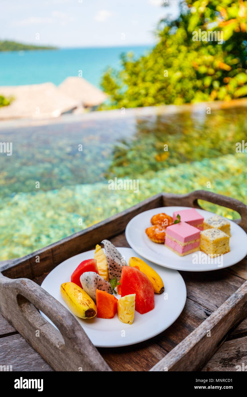 Zimmerservice leckeres Obst und Süßigkeiten auf einem Tisch in der Nähe der Pool serviert Stockfoto