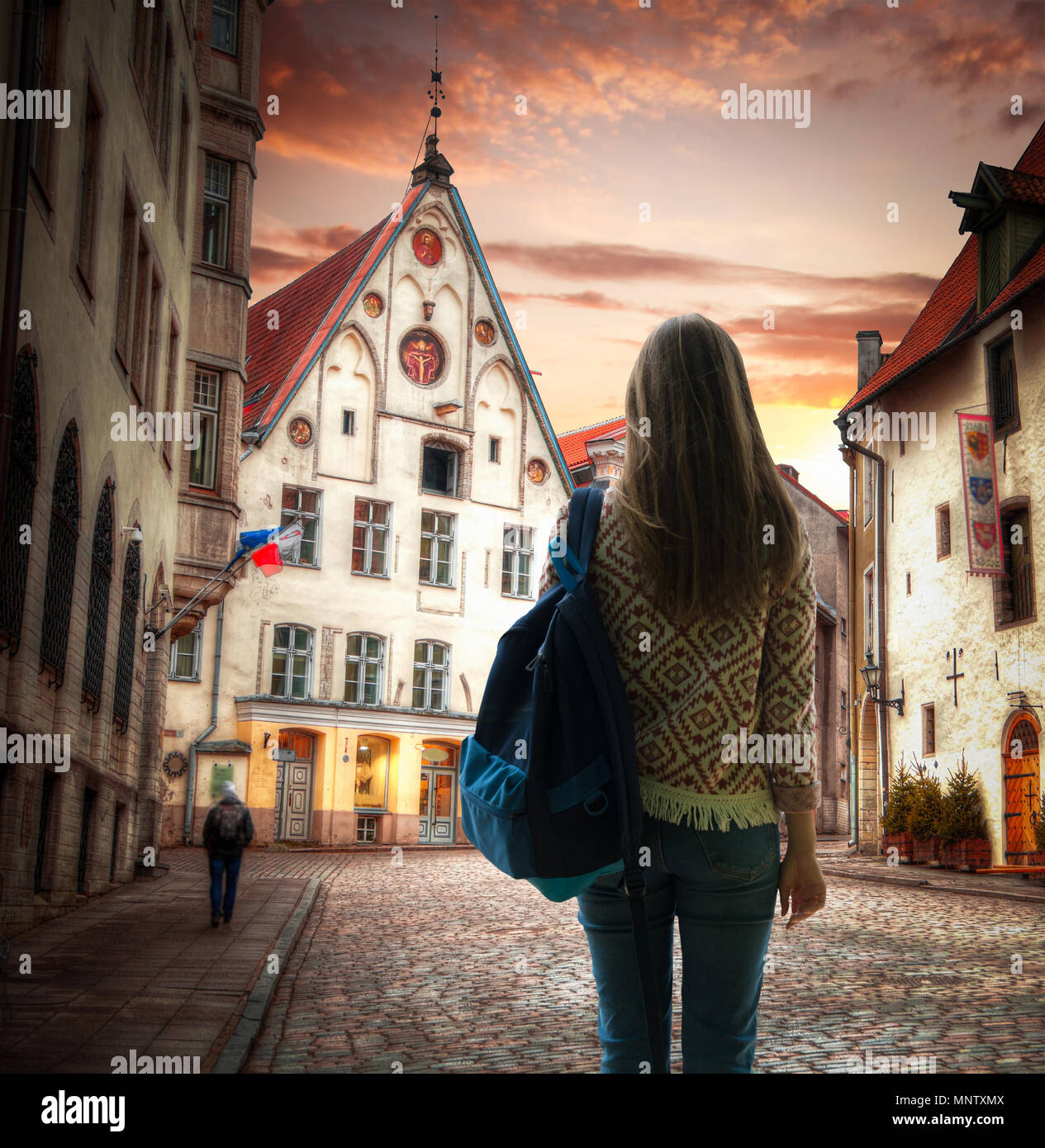 Girl traveler steht mit einem Rucksack in den Hintergrund von Tallinn. Stockfoto