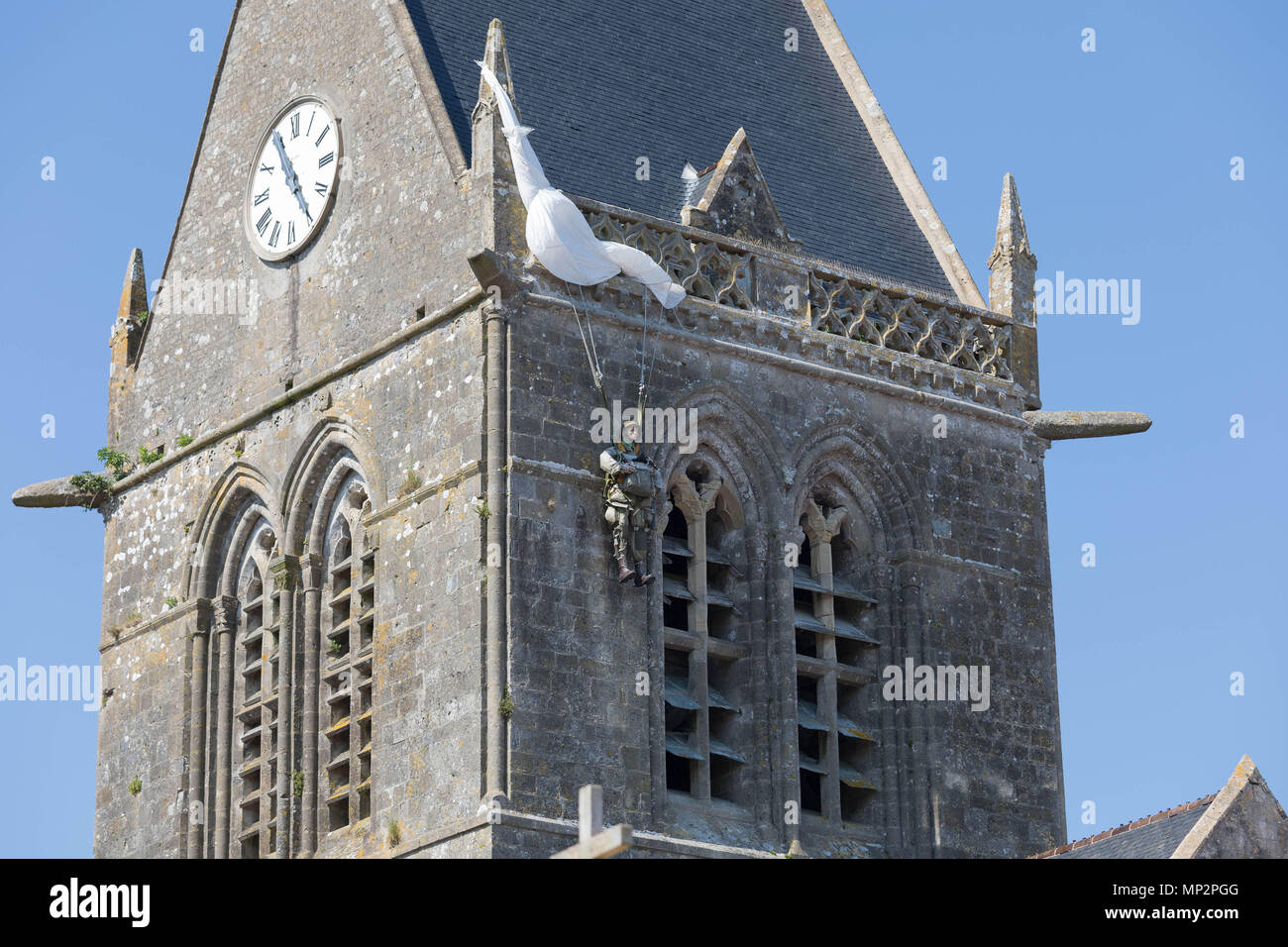 Sainte-Mere-Eglise, Normandie, Frankreich, 15. Mai 2018 DDAY Denkmal für die amerikanischen Fallschirmjäger' John Steele' auf der Spitze des Kirchturms Stockfoto