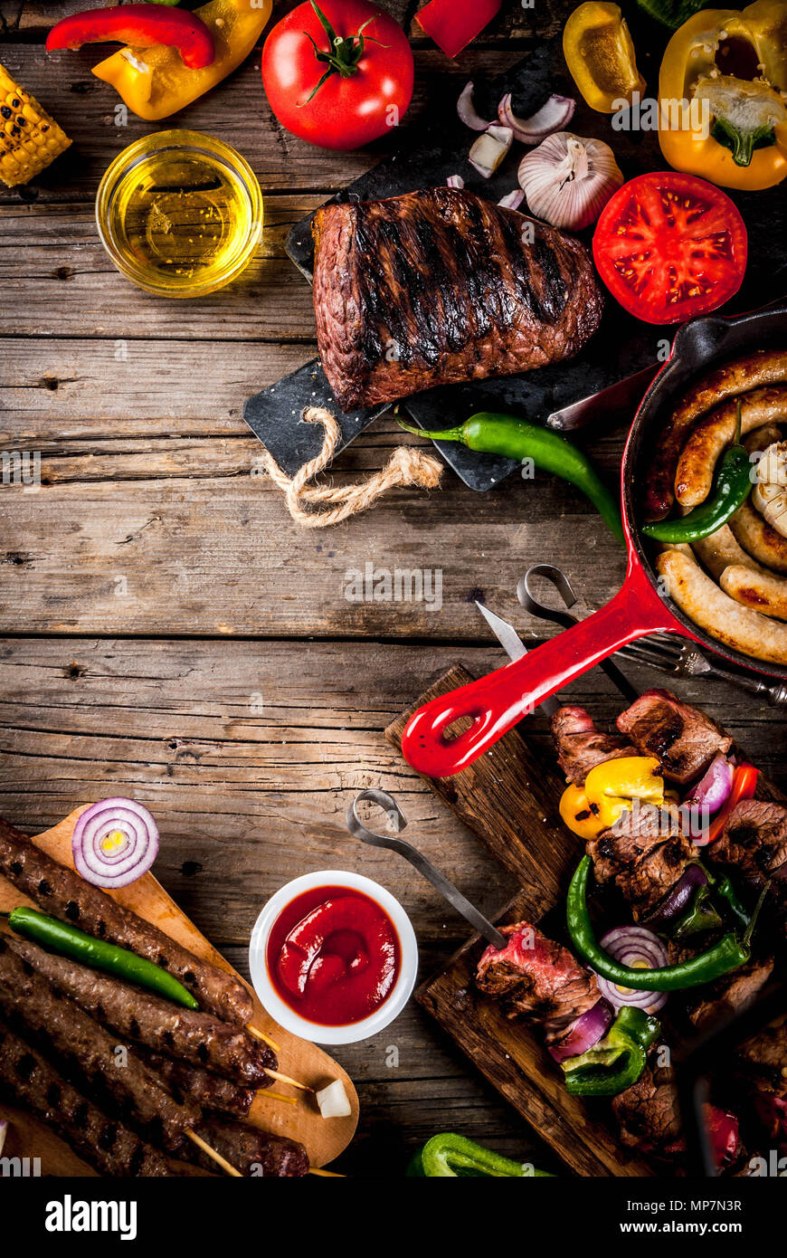 Sortiment verschiedene Barbecue Grill Fleisch, bbq Party fest - Shish Kebab, Würstchen, gegrillten Fleisch Filet, frisches Gemüse, Soßen, Gewürze, auf alten Woo Stockfoto