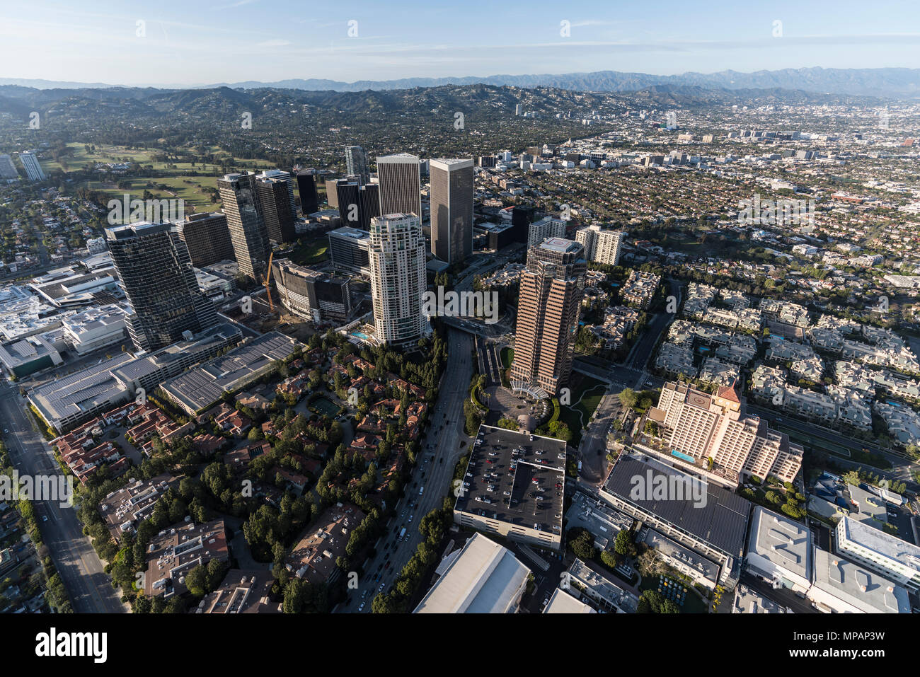 Luftaufnahme von Los Angeles Century City Towers und Olympic Bl mit Beverly Hills und Santa Monica Mountains im Hintergrund. Stockfoto