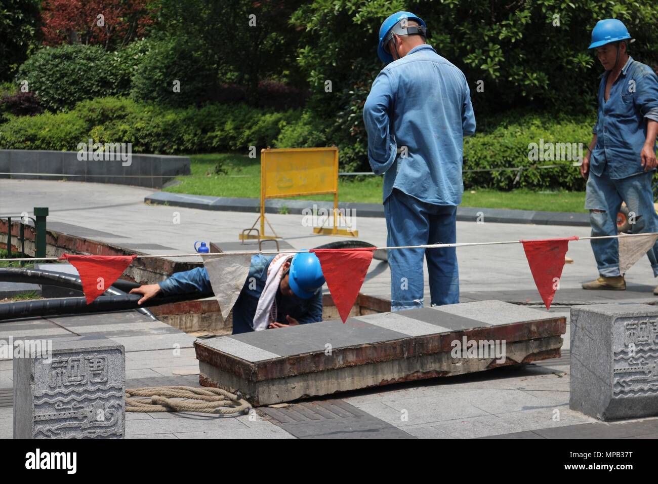 Arbeitnehmer Ausführen von Wartungsarbeiten auf der Straße Bürgersteig Stockfoto