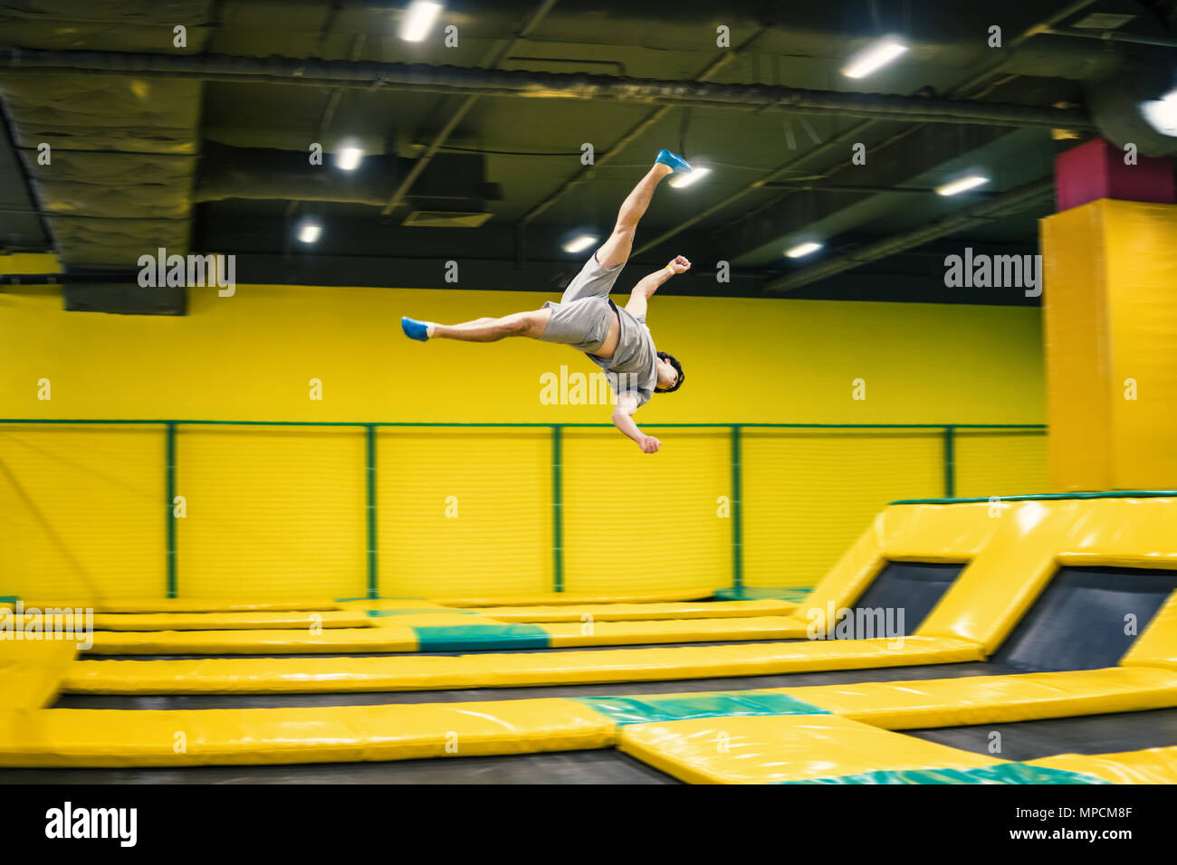 Trampoline Jumper führt akrobatische Übungen auf dem Trampolin Stockfoto