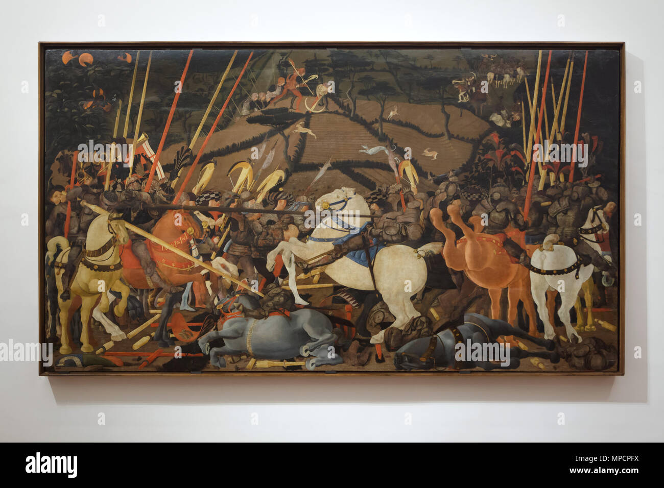Gemälde "Die Schlacht von San Romano" (1435-1440) von der italienischen Renaissance Maler Paolo Uccello in den Uffizien (Galleria degli Uffizi) in Florenz, Toskana, Italien. Das Gemälde ist ein Teil eines Zyklus von drei Gemälde, die einen Sieg der Florentiner über die Siena San Romano in der Nähe von Pisa 1432. Stockfoto