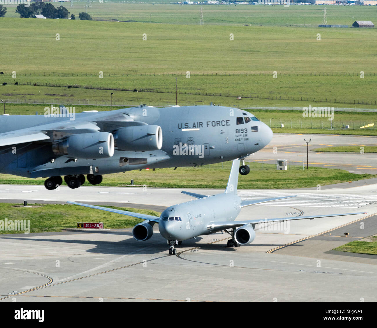 Eine Boeing KC-46A Pegasus bei Travis Air Force Base, Calif., während als C-17 Globemaster III ab, März 7, 2017 eintrifft. Travis war als bevorzugter Ort für die Luftwaffe der neuesten Betankung von Flugzeugen im Januar ausgewählt. Dies ist das erste Mal das Flugzeug an einem Air Mobility Command Base geflogen ist und wird festgelegt, Boden- und Flugtests während seiner Zeit bei Travis zu vervollständigen. (U.S. Air Force Foto von Louis Briscese) Stockfoto