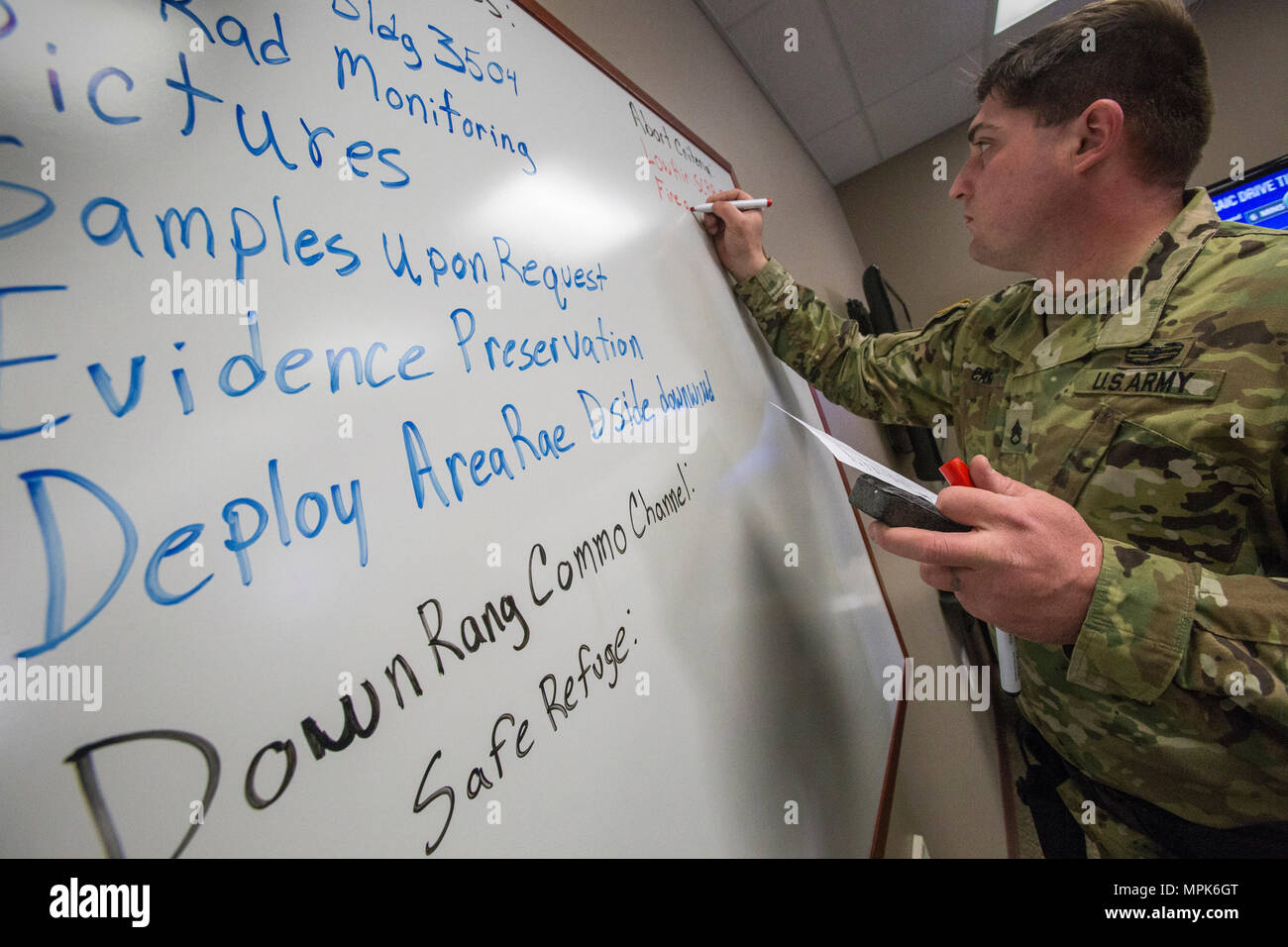 Staff Sgt. William Camp, mit 21 Waffen der New Jersey National Guard von Mass Destruction-Civil Support Team, Listen der Streik Teams' mission Abbruchkriterien während einer Übung mit dem Picatinny Arsenal Feuerwehr am New Jersey Homeland Defense Homeland Security Center am Picatinny Arsenal, N. J., März 23, 2017. Das 21 WMD-CST ist eine gemeinsame Einheit aus New Jersey National Guard Soldaten und Piloten, deren Aufgabe es ist, die zivilen Autoritäten durch die Identifizierung von chemischen, biologischen, radiologischen und nuklearen Stoffen entweder in man-made oder Naturkatastrophen. (New Jersey Stockfoto