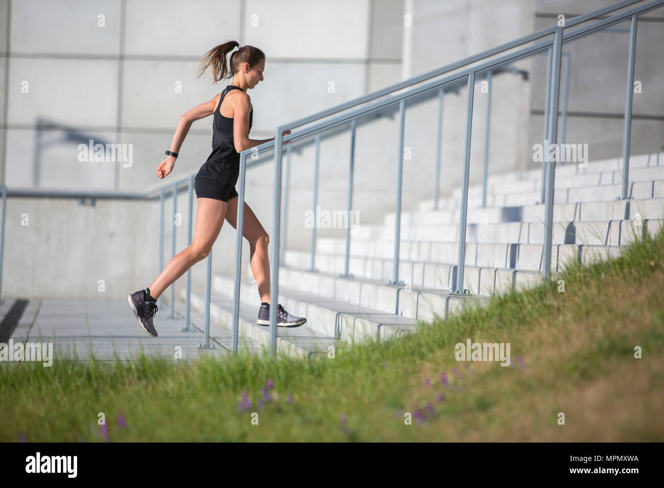 Weibliche Urban Runner Ausbildung auf Beton Treppe Stockfoto