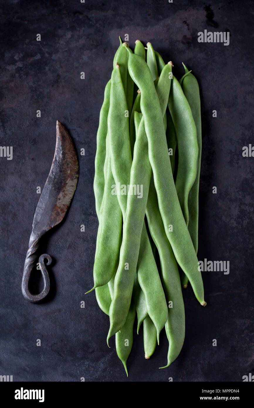 Bohnen und einem alten Messer auf Dark Metal Stockfoto