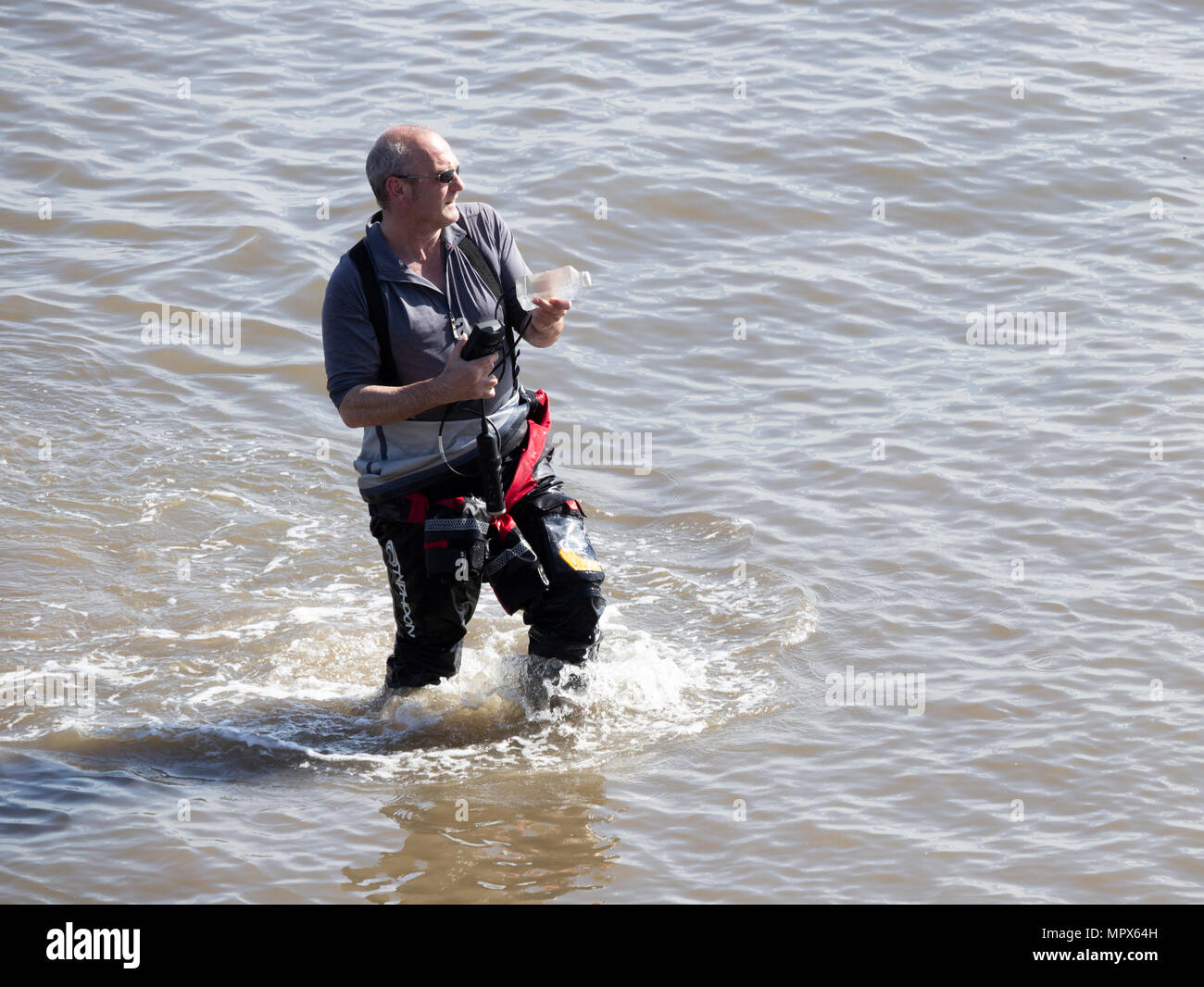 Umweltagentur Arbeiter unter Wasser Probe aus der Nordsee an saltburn am Meer, North Yorkshire, England. Großbritannien Stockfoto
