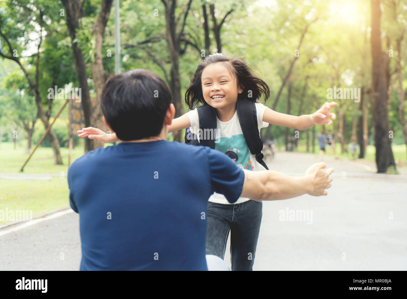 Asiatische Mädchen Kinder Schüler laufen in Vaters € ™ s Hände zu ihren Hug nach zurück in die Schule. Schüler Student. Stockfoto