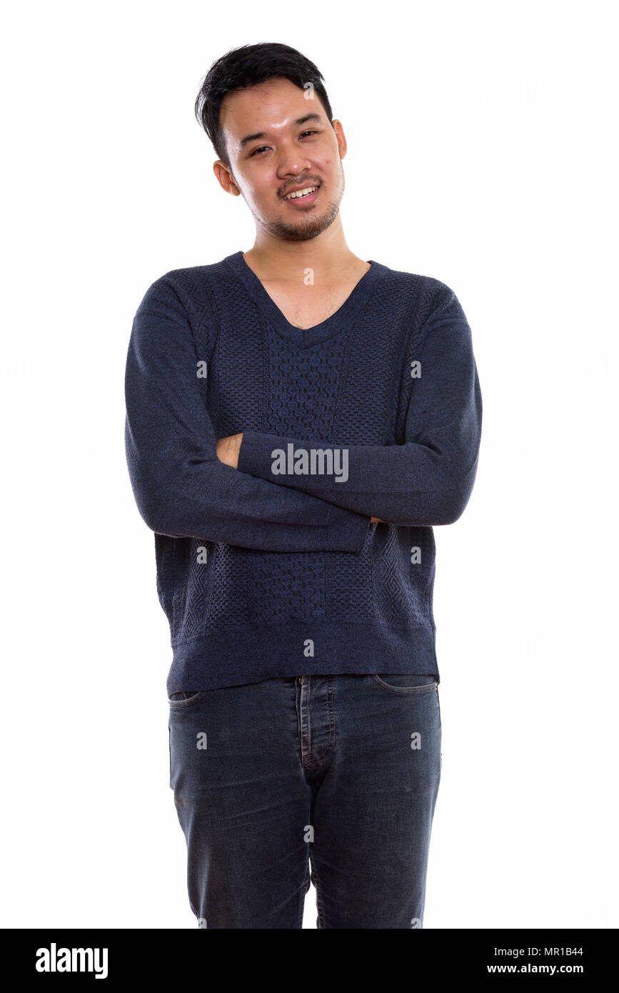Studio shot junger asiatischer Mann glücklich lächelnd und mit einem Stockfoto