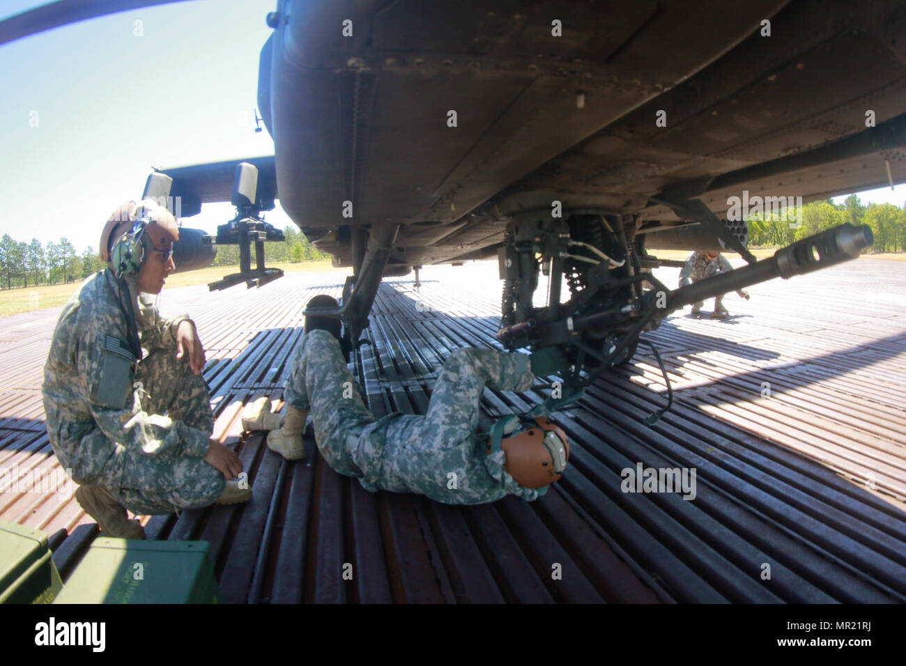 Kampfhubschrauber Reparateure in den 1 Angriff Reconnaissance Bataillon zugeordnet, 82nd Combat Aviation Brigade stellen Sie sicher, dass die Schrauben an der M230 Chain Gun, die eine AH-64D Apache Helikopter befestigt vor dem Flug in Fort Bragg, N.C., 2. Mai angezogen sind. (U.S. Armee Foto von Sgt. Steven Galimore) Stockfoto