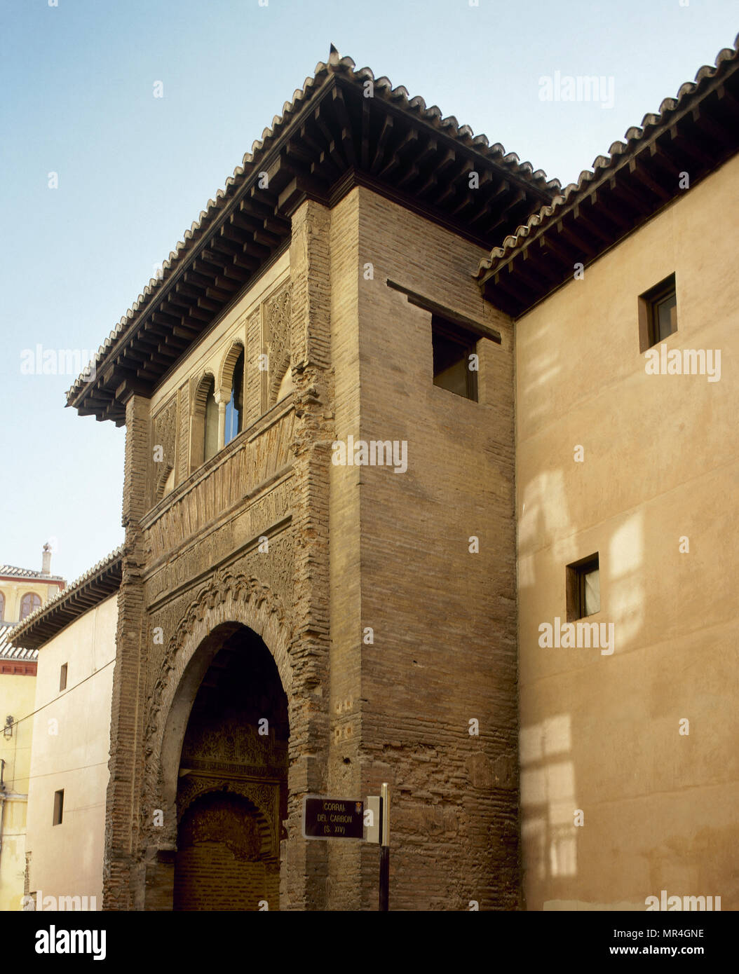 Granada, Andalusien, Spanien. Die Corral Corral del Carbon (Kohle). Blick auf die Fassade, die mit einem grossen Hufeisen Arch. Architektonisches detail. Es ist eines der wichtigsten Gebäude aus Granada's Nasriden Zeitraum erhalten. Es hat viele Verwendungen in der Geschichte hatte. Die Corral del Carbon war im 16. Jahrhundert als Khan, in der Mitte des kommerziellen Bereich aufgebaut. Nach 1531 war es, als Corral del Carbon genannt wegen seiner Verwendung als Speicher für Kohle. Im 16. Jahrhundert wurde angepasst für Casa De Comedias (Haus der Komödien). Vom 17. Jahrhundert an in kleine Apartments umgewandelt wurde w Stockfoto