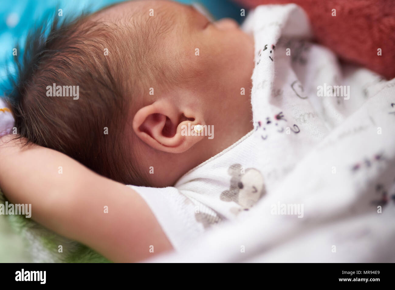 Neugeborenes Baby mit Ohrring Nahaufnahme schlafen Stockfoto
