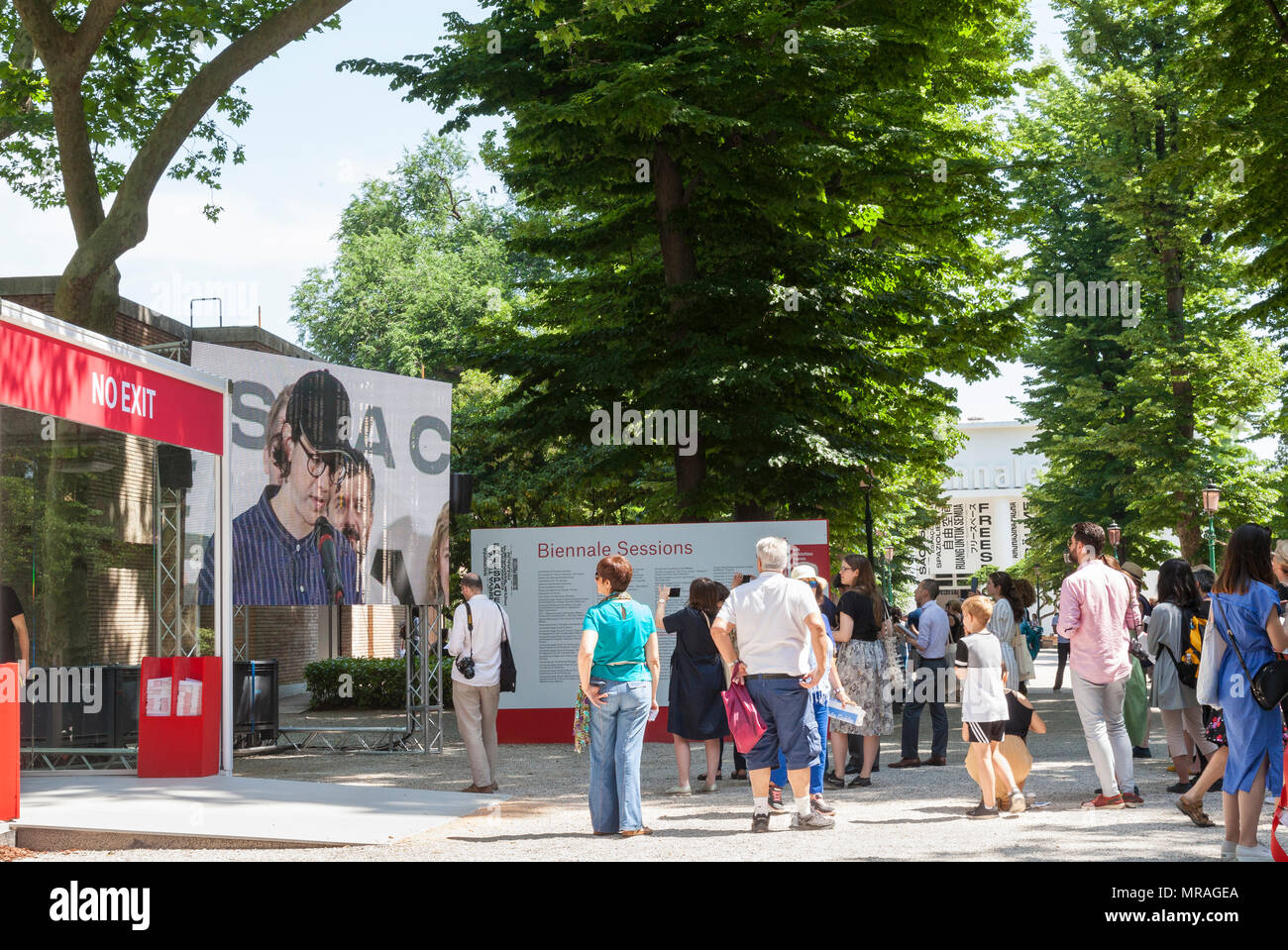 Venedig, Venetien, Italien. 26. Mai 2018. Der Eröffnungstag der 2018 Architektur Biennale berechtigt Freespace in Giardini Pubblici (öffentliche Gärten) Castello. Leute, die vor der Venezianischen Biennale Pavillon steht gerade eine Wiederholung der Zeremonie des Vortages Awards mit einem Mitglied der Schweizerischen contingengcy ihre Goldenen Löwen auf dem Bildschirm zu akzeptieren. Kredit MLCpics/Alamy leben Nachrichten Stockfoto