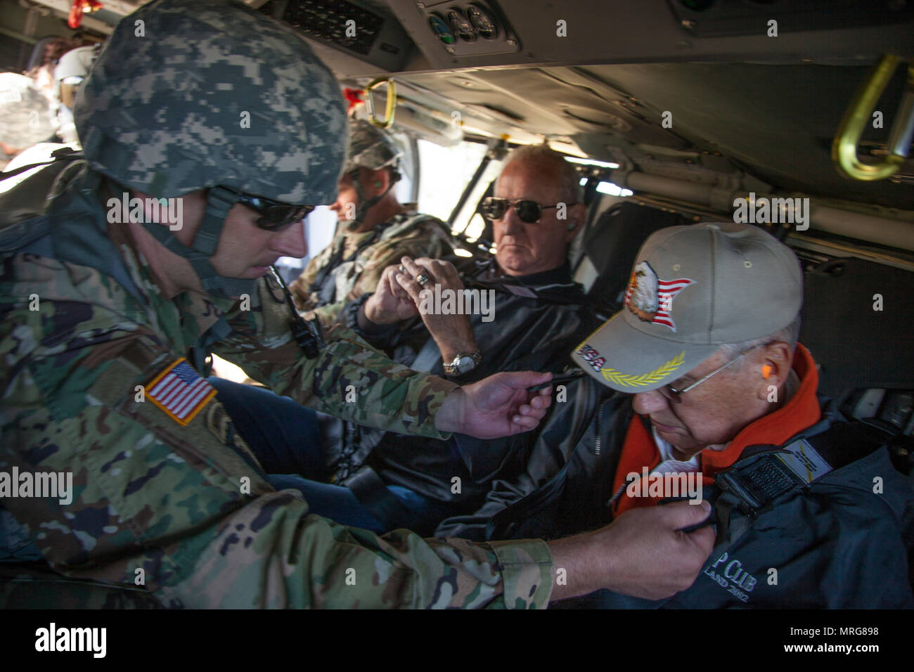 Us-Armee Oberstleutnant Steven Sewell mit Joint Force Head Quarters, South Dakota Army National Guard unterstützt Lawrence Weiss Mitglied der South Dakota der militärischen Angelegenheiten, die mit dem Kabelbaum der ein HH-60 M MEDEVAC Black Hawk während des goldenen Coyote Übung in Rapid City, S.D., 15. Juni 2017. Die goldenen Coyote Übung ist eine dreiphasige, Szenario-driven Übung in den Black Hills von South Dakota und Wyoming, mit dem Kommandanten auf der Mission wesentliche Anforderungen der Aufgabe, Krieger Aufgaben und Übungen zu konzentrieren. (U.S. Armee Foto von SPC. Kevin Kim) Stockfoto