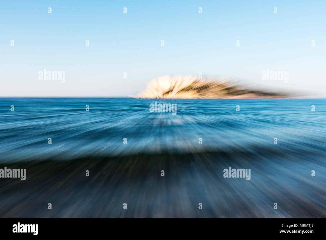 Abstrakte Beschleunigung wie Zoom über das Meer mit einer Insel am Horizont. Stockfoto