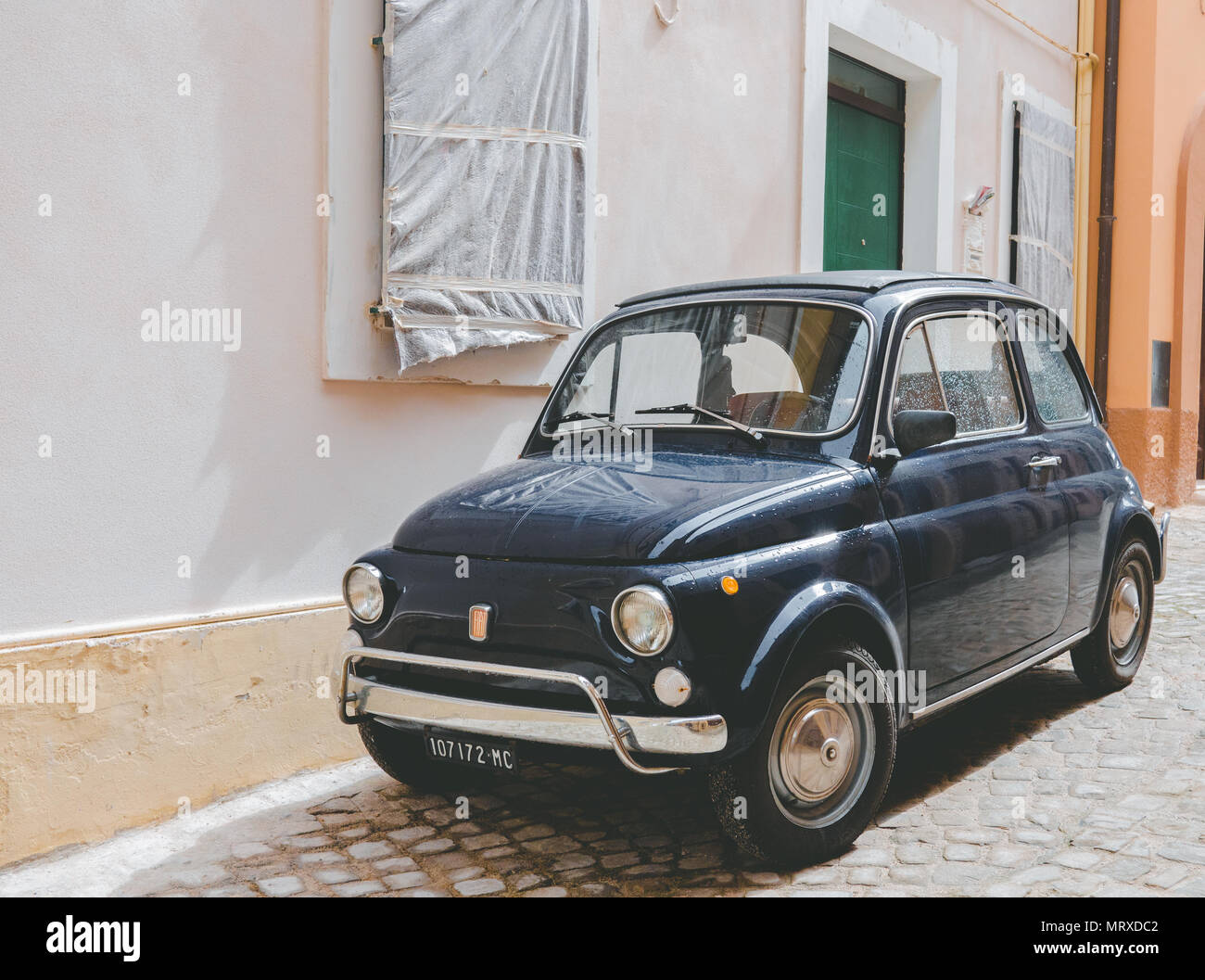 Einen alten blauen Italienischen 500 Auto ist auf einer Italienischen typische Straße geparkt Stockfoto