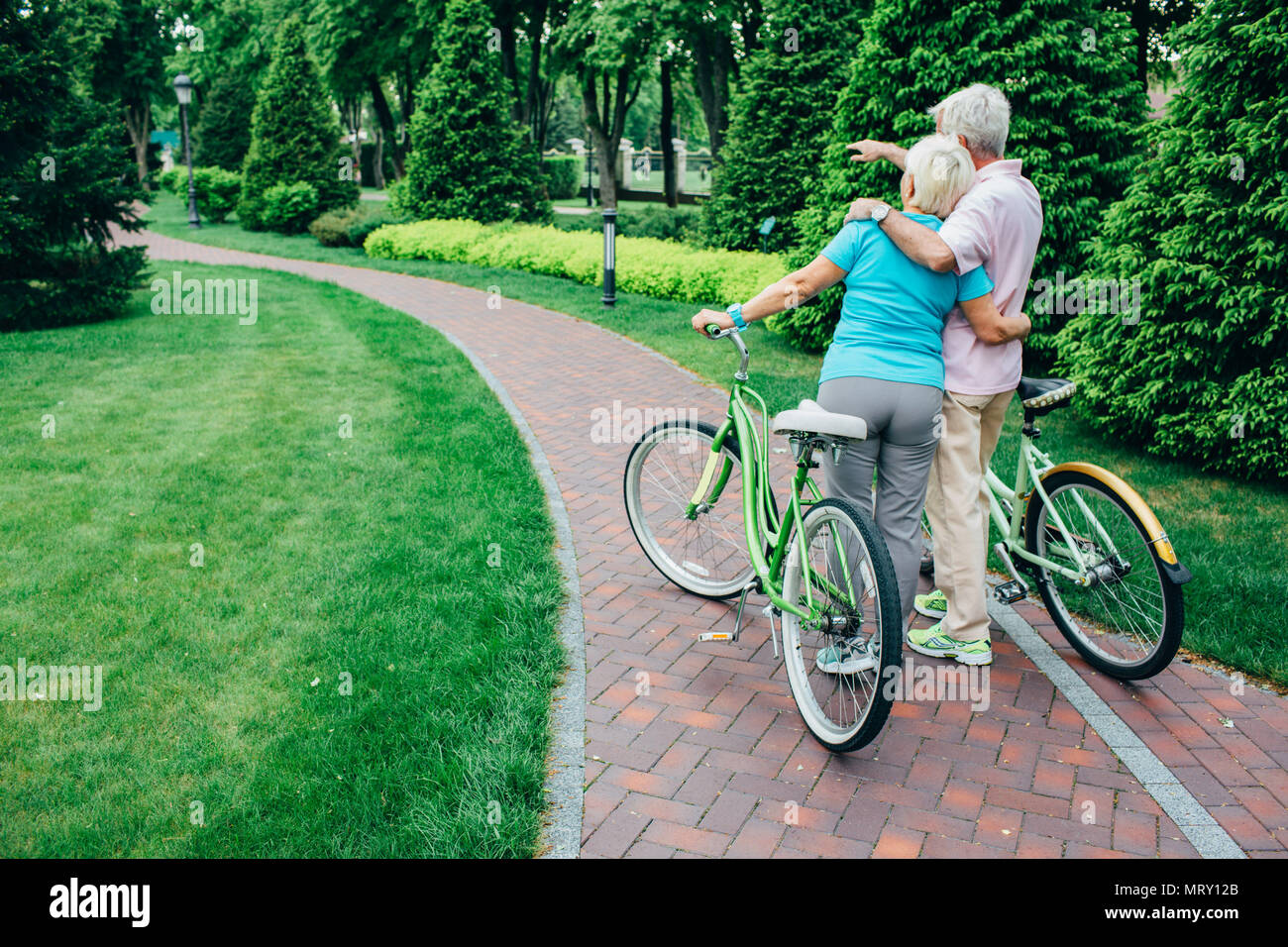 Senior Paar mit ihren Fahrrädern im Park, Ansicht von hinten Stockfoto