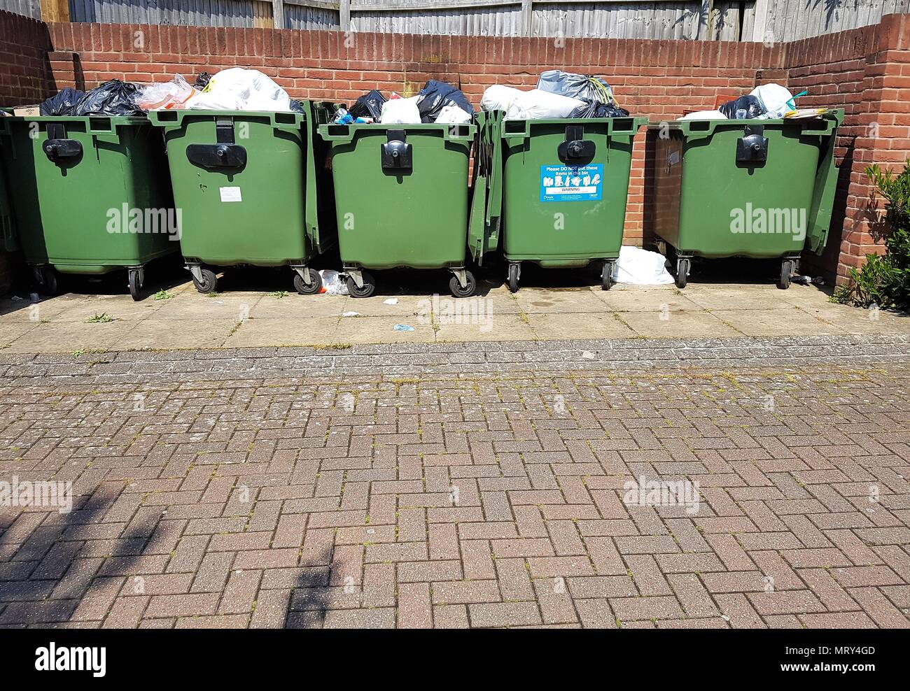 Reihe der Grünen wheelie Bins mit Müll gefüllt Stockfoto