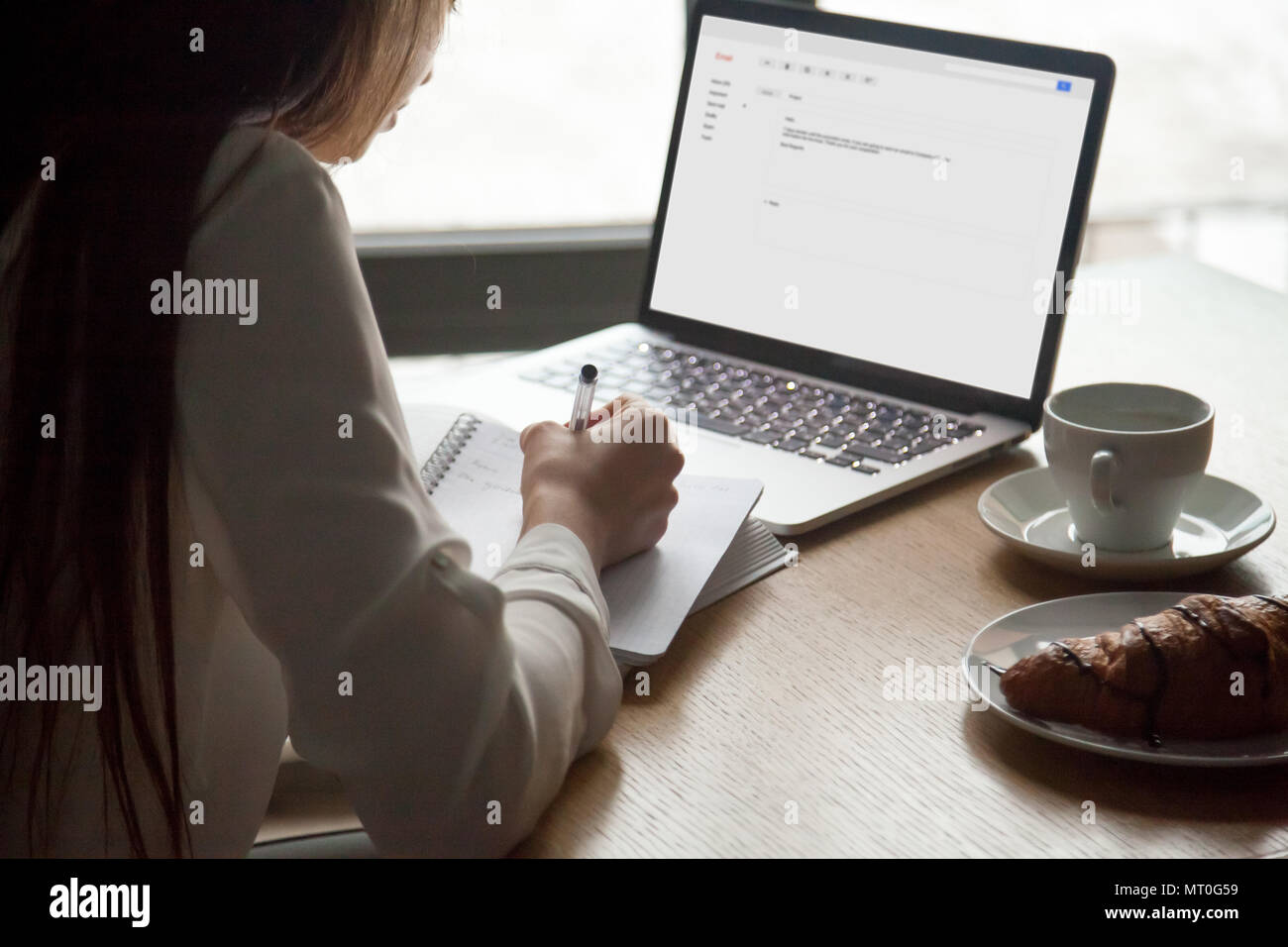 Frau, die Noten lesen von e-mails schreiben auf Laptop im Cafe Stockfoto