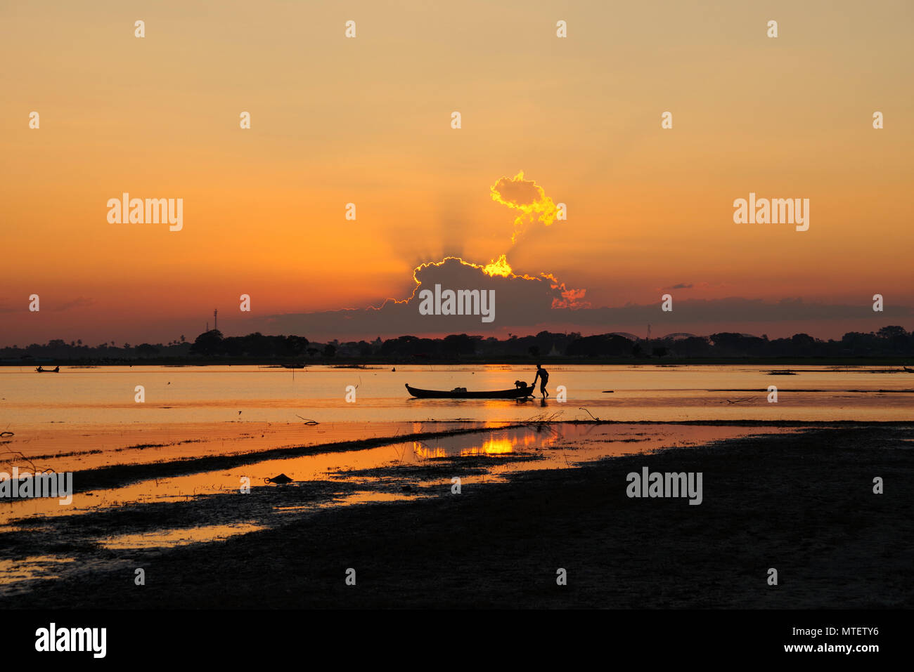 Traditionelle Boot Silhouette bei Sonnenuntergang auf Taung Tha Mann See, Amarapura, Mandalay, Myanmar Stockfoto