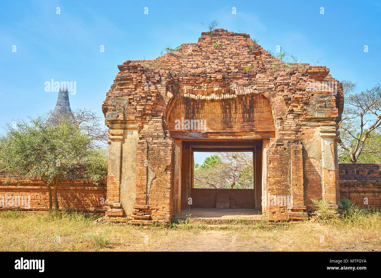 Die Ruine der Tore von nagayon Tempel mit Somingyi Tempel auf dem Hintergrund, Bagan, Myanmar Stockfoto