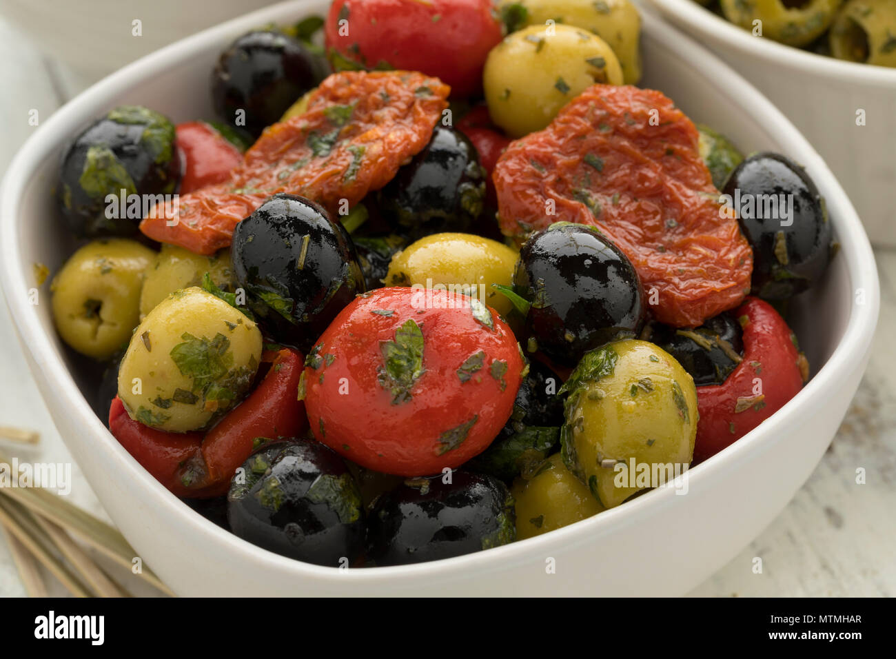 Schüssel mit grünen und schwarzen Oliven, Paprika und Tomaten als Snack Nahaufnahme Stockfoto