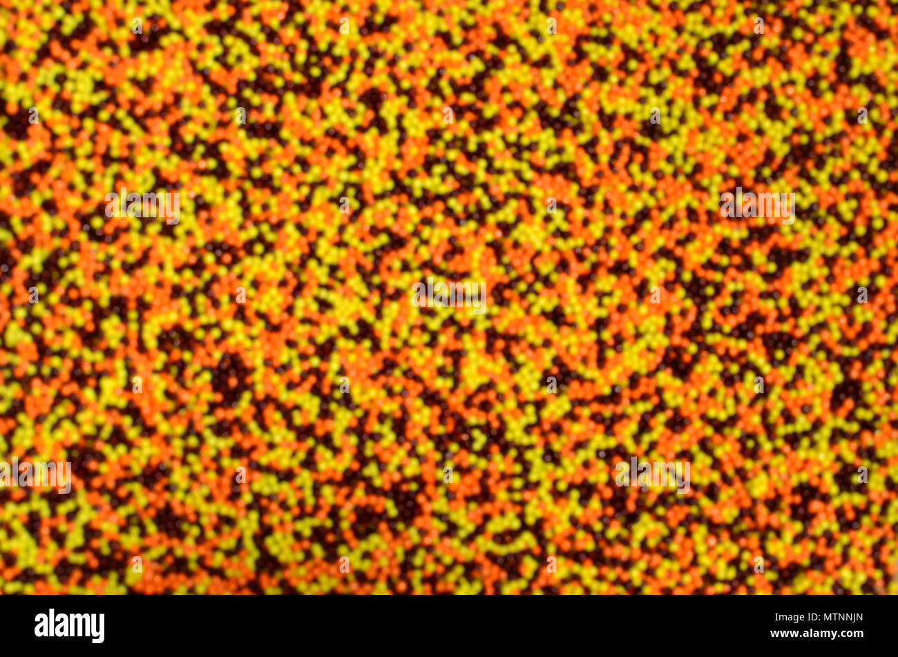 Unscharfes Bild aus einer Vielzahl von farbigen verglaste Pulver in Form von kleinen Kugeln. Defokussierten Bild der bunten Perlen von sehr kleinen Größe für die Dekoration Stockfoto