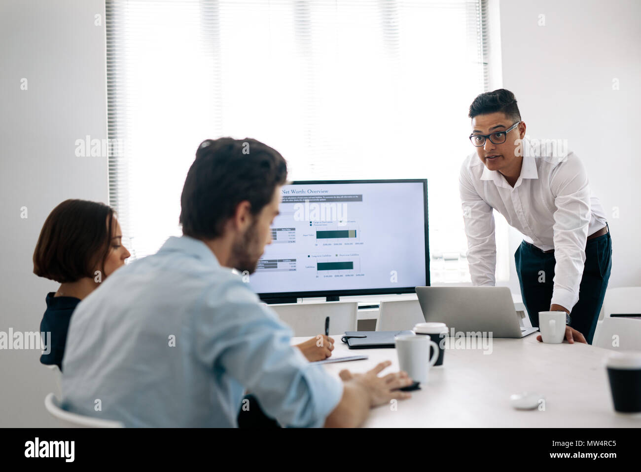 Geschäftsmann eine Darstellung an seine Kollegen im Büro. Büro Kollegen Notizen im Konferenzraum sitzen beim Abhören einer Pres Stockfoto
