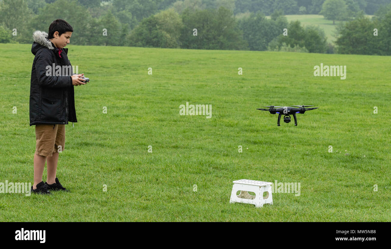 Biracial junge fliegt Drone bei Weald Country Park Model Release statt Stockfoto