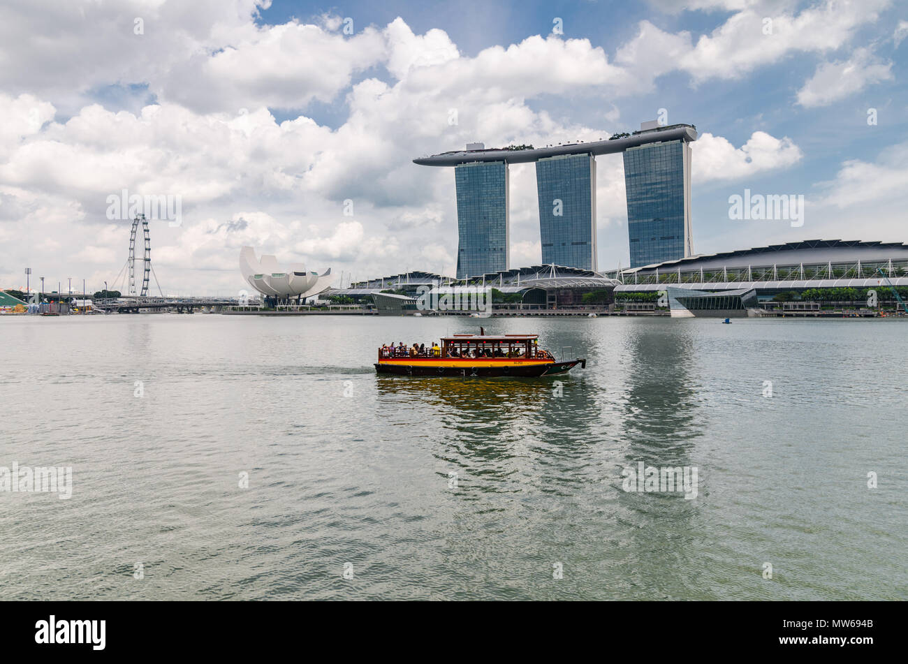 Ein Kreuzfahrtschiff, bekannt als twakows fahren die berühmte Marina Bay Sands Hotel. Das Schiff war für den Transport entlang des Singapore River verwendet. Stockfoto