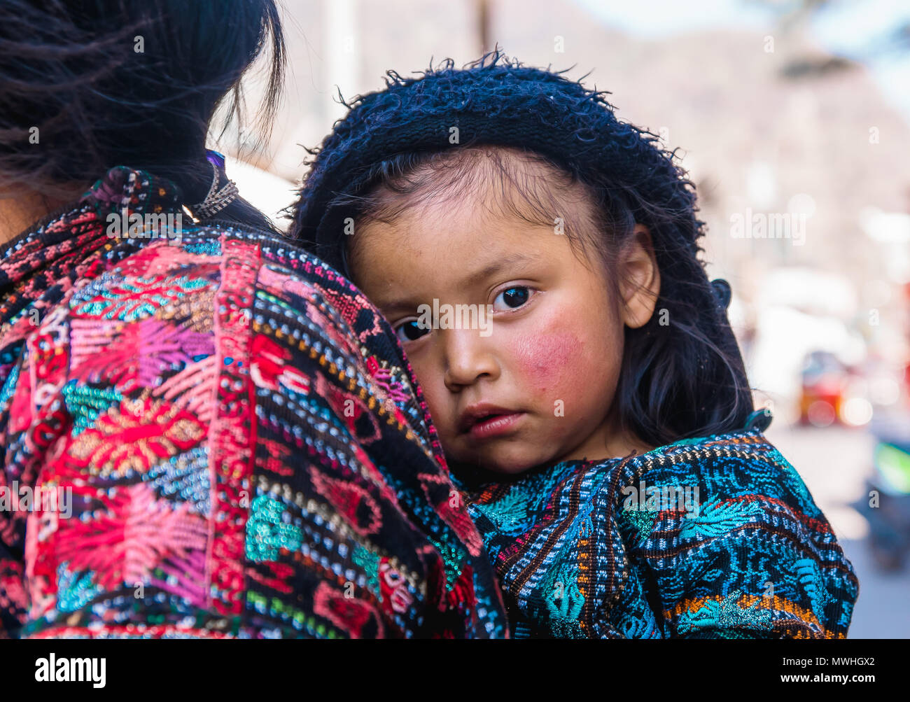 Panajachel, Guatemala - April, 25, 2018: Im Freien von unbekannten indischen Frau mit Baby auf der Rückseite nimmt an den lokalen Markt am Atitlan See, Guatemala Stockfoto