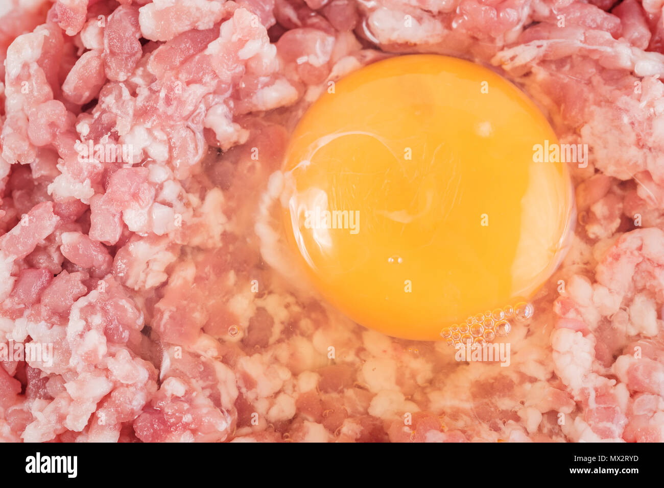 Boden Schnitzel oder hamburger mit Huhn Eigelb auf weißem Hintergrund. Close-up. Stockfoto