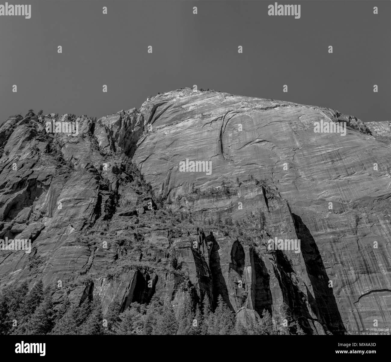 Hohe Solid Rock Mountain mit Klippen unter freiem Himmel, Schwarz und Weiß. Stockfoto