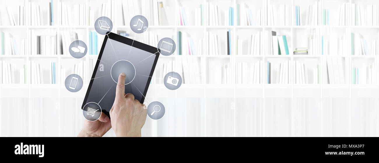 Hand berühren digitalen Tablet mit Symbolen auf Bibliothek Hintergrund isoliert Stockfoto