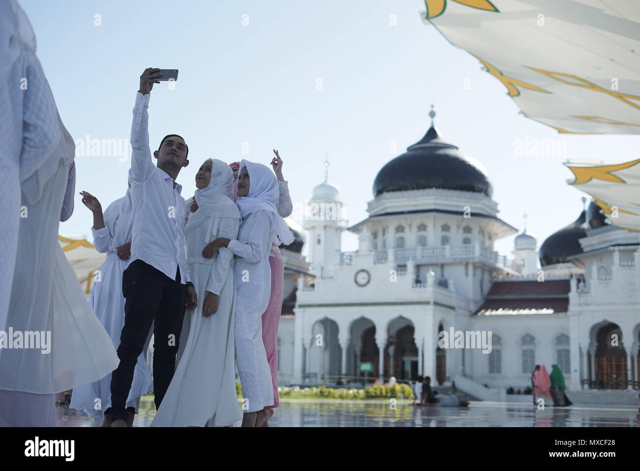 Banda Aceh, Aceh/Indonesien - 3. Juni 2018: Touristen fotografieren/selfie vor der Großen Moschee Baiturrahman in Banda Aceh, Indonesi Stockfoto