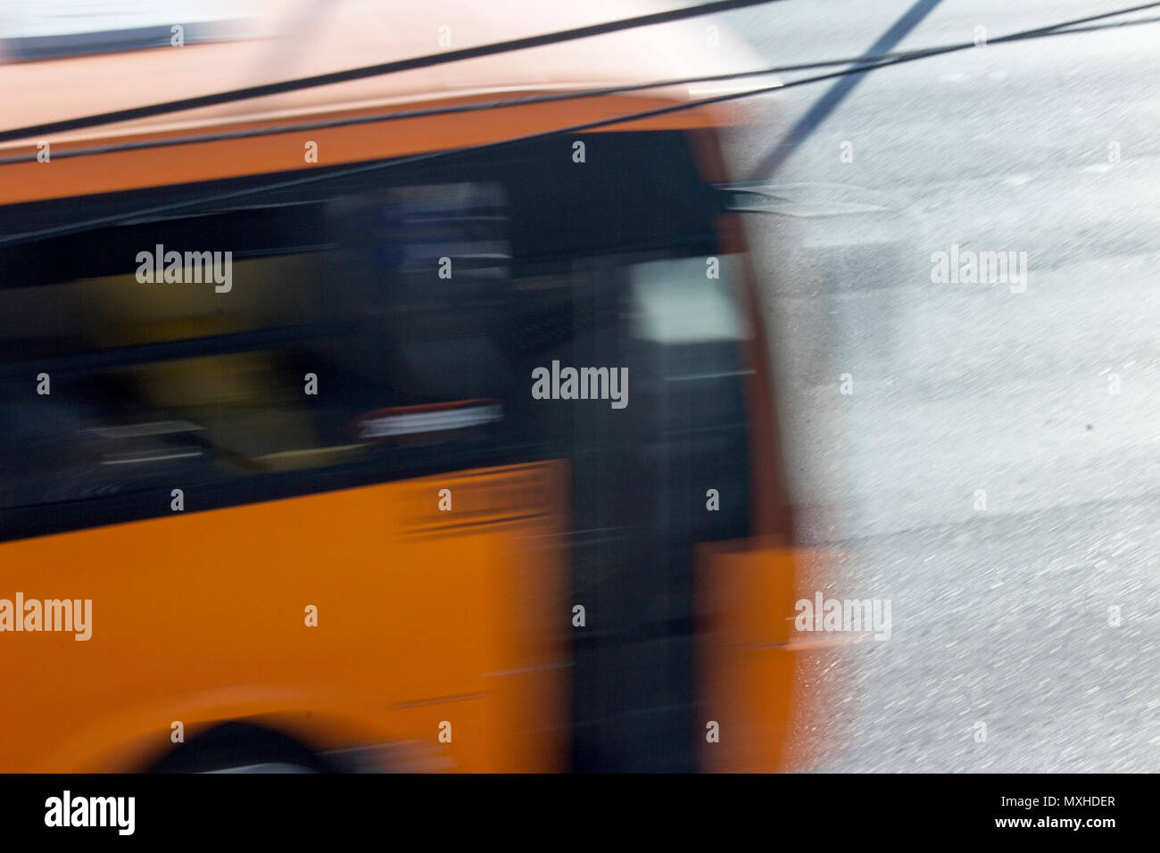 Eine orange öffentlichen Bus Transite in einer Allee von Monterrey, Nuevo Leon, Mexiko, am Nachmittag. Stockfoto