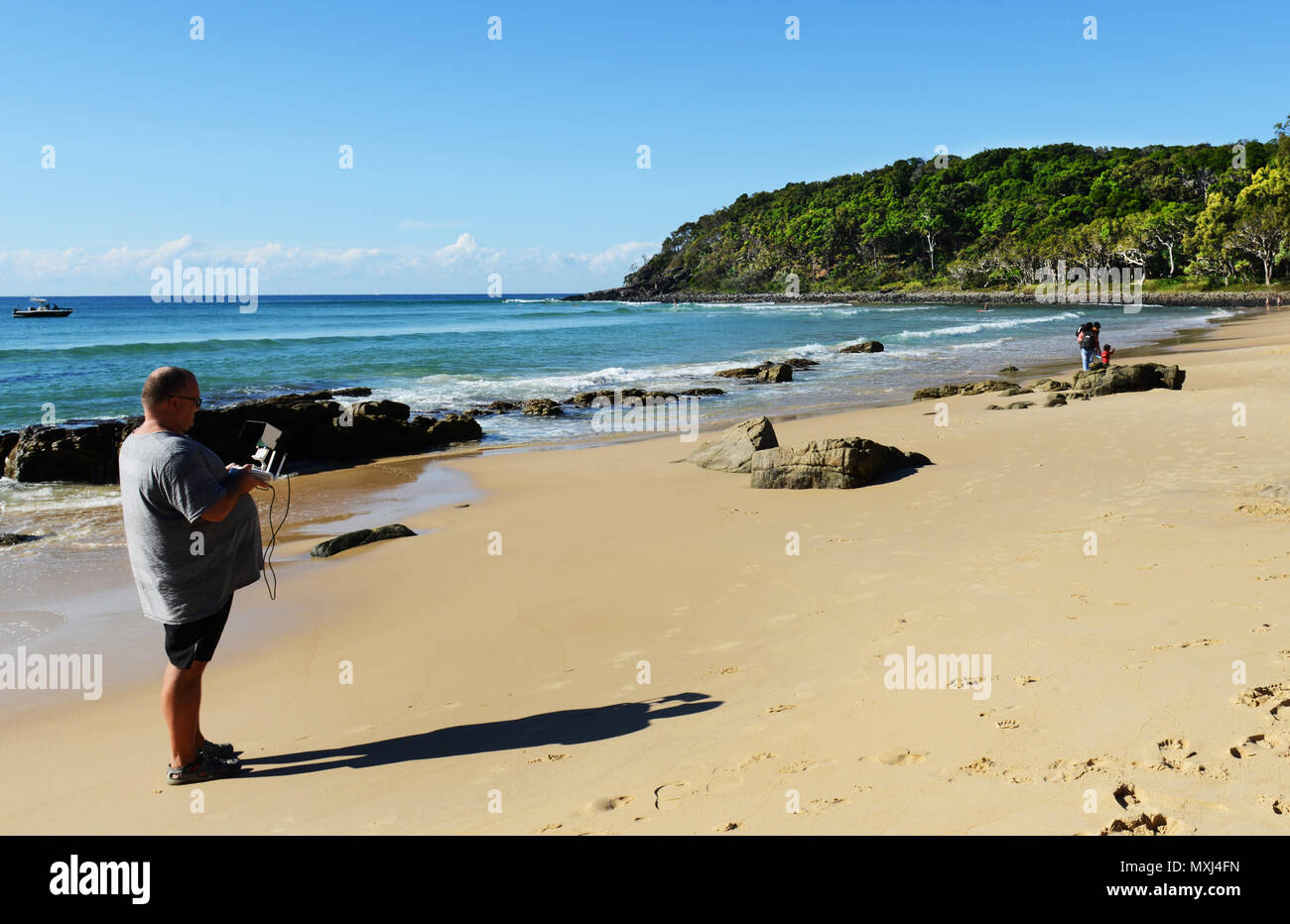 Ein Mann Betrieb seiner DJI Drone am Strand von Noosa National Park. Stockfoto
