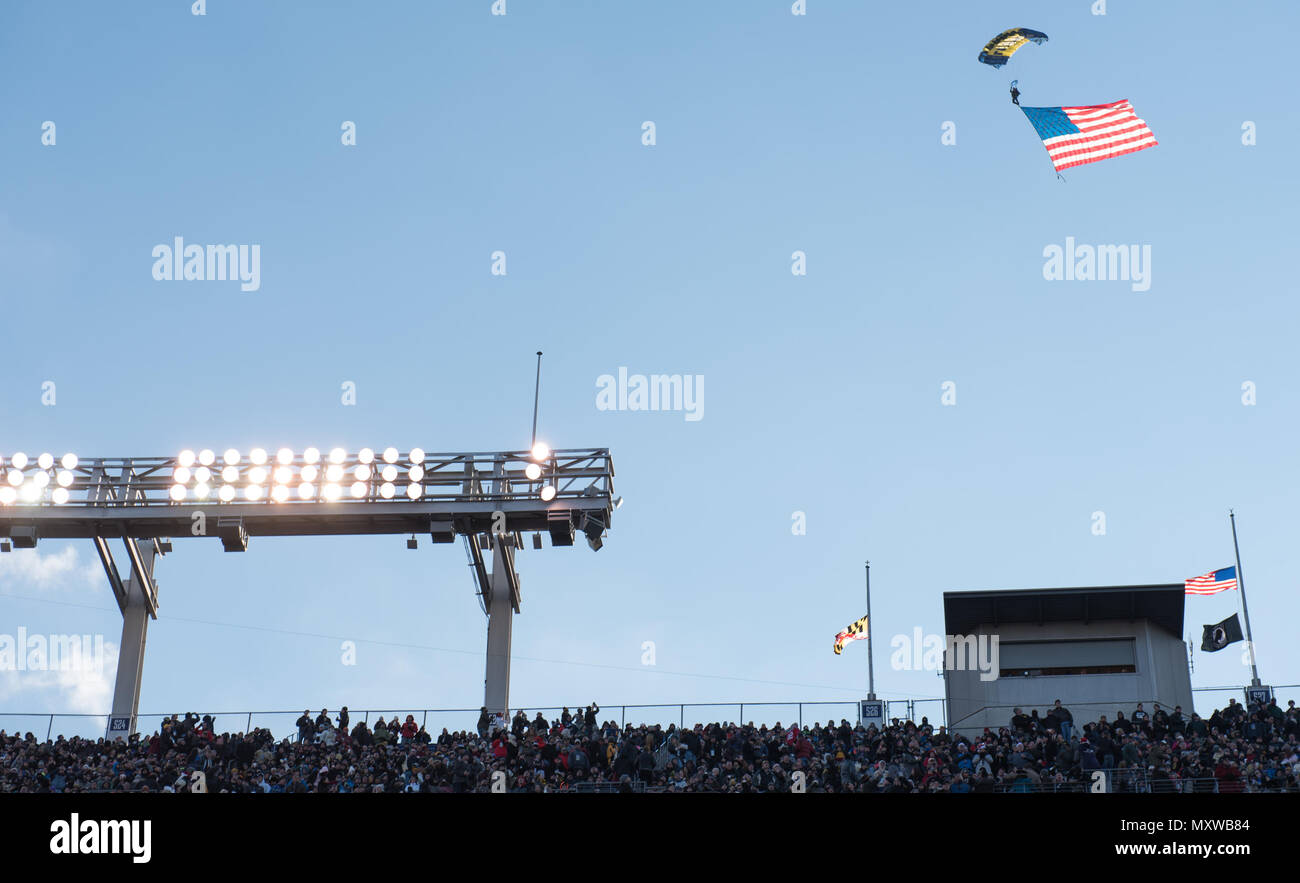 Ein Mitglied der US-Navy Seal Leap Frogs Fallschirm Team M&T Bank Stadium vor der Armee Marine Spiel 2016 in Baltimore, Md., 10.12.2016. Das US-Militär Akademie Kadetten von West Point brach eine 14-marine Streifen gewinnen nach dem Sieg über die US Naval Academy Midshipmen 21-17. (DoD Foto von U.S. Army Sgt. James K. McCann) Stockfoto