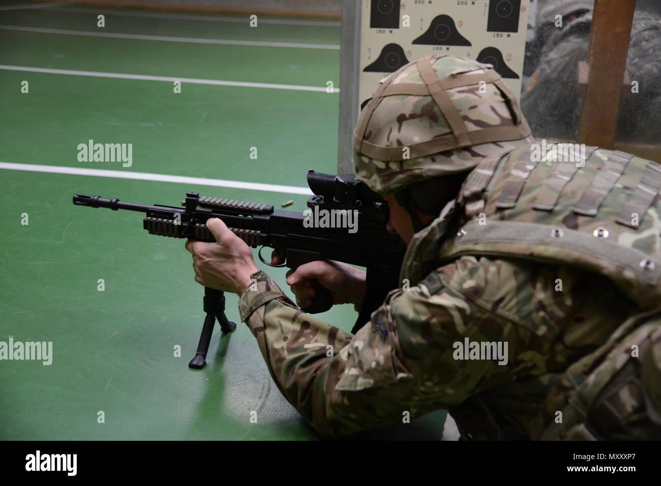 Ein Mitglied der Britischen Streitkräfte, die an die lokalen Einheiten zugeordnet, zielt darauf ab, ein Ziel in Bauchlage unterstützt Position während der L 85 A2 rifle Kalibrierung bei der Schulung Support Center Benelux 25 m Reichweite im Innenbereich, in Chièvres Air Base, Belgien, November 30, 2016. Die britischen Truppen unter Aufsicht der britischen Joint European Training Team (USA ausgebildet Armee Foto durch visuelle Information Specialist Pascal Demeuldre) Stockfoto